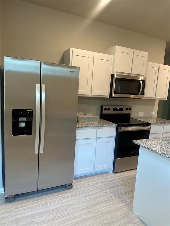 3008 Pecan Farm Lane Fort Worth, TX 76140 - Photo 4 of 10 a kitchen with a refrigerator sink and microwave