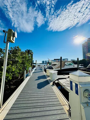 a view of a balcony with chairs and wooden floor