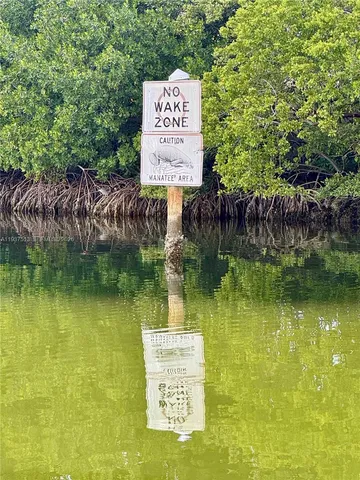 a sign board with a lake view