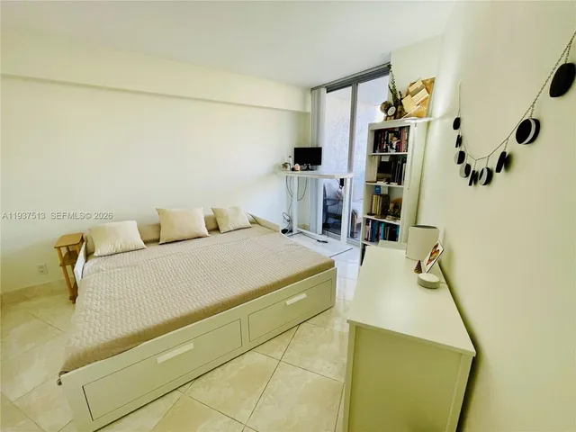 a bedroom with a bed and walk in closet