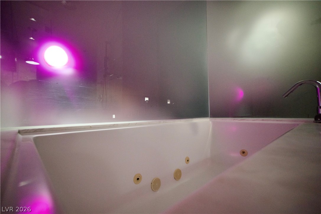 4381 West Flamingo Road, Unit 3616 Las Vegas, NV 89103 - Photo 13 of 29 Luxuriate in the jetted tub, enveloped by ambient lighting for ultimate relaxation.