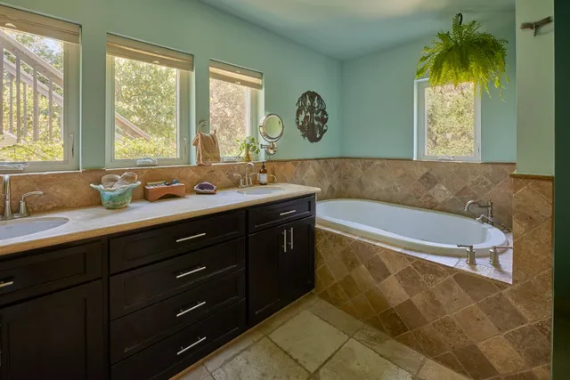 a dining hall with stainless steel appliances granite countertop a stove a refrigerator a sink dishwasher a dining table and chairs with wooden floor