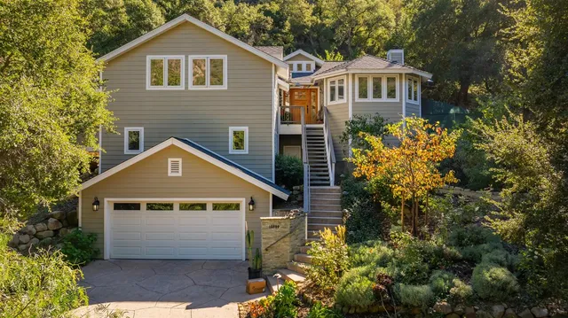 a front view of a house with a yard and garage