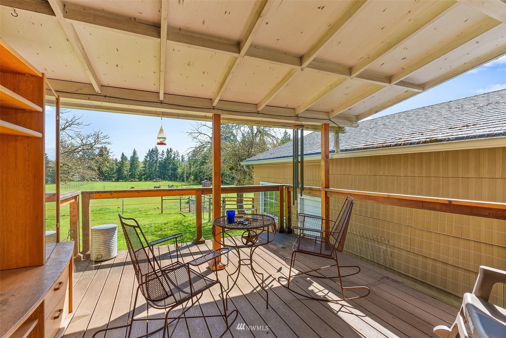479 Chilvers Road Chehalis, WA 98532 - Photo 21 of 37 a view of a balcony with chairs and wooden floor