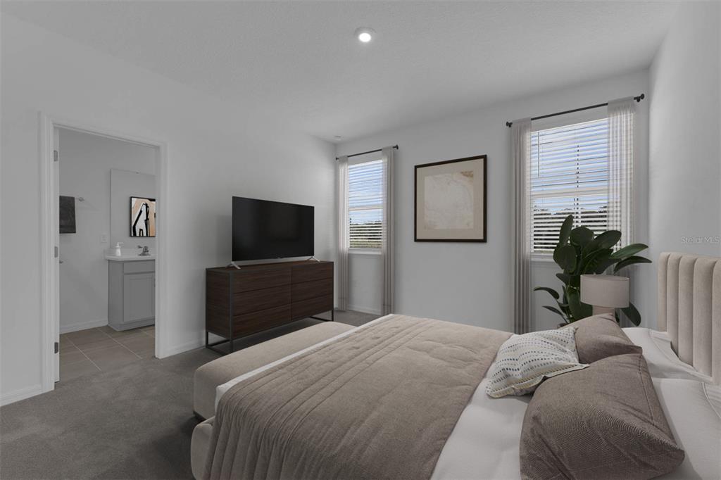 1812 Shadow Box Bend St. Cloud, FL 34771 - Photo 15 of 33 a bedroom with a bed and a flat screen tv
