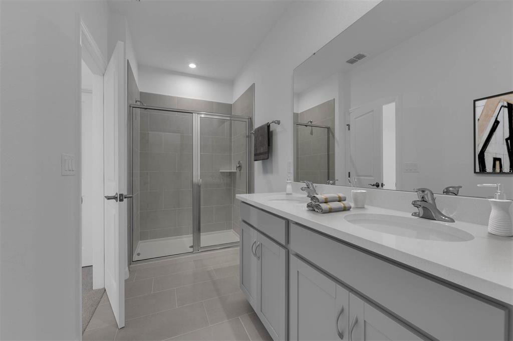 1812 Shadow Box Bend St. Cloud, FL 34771 - Photo 16 of 33 a bathroom with a double vanity sink mirror and double