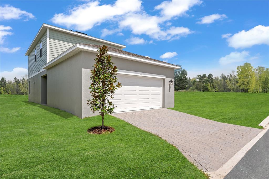 1812 Shadow Box Bend St. Cloud, FL 34771 - Photo 17 of 33 a house view with a garden space