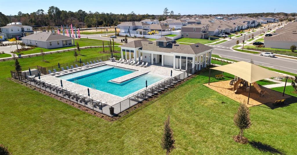 1812 Shadow Box Bend St. Cloud, FL 34771 - Photo 24 of 33 a view of a swimming pool with a garden and seating area