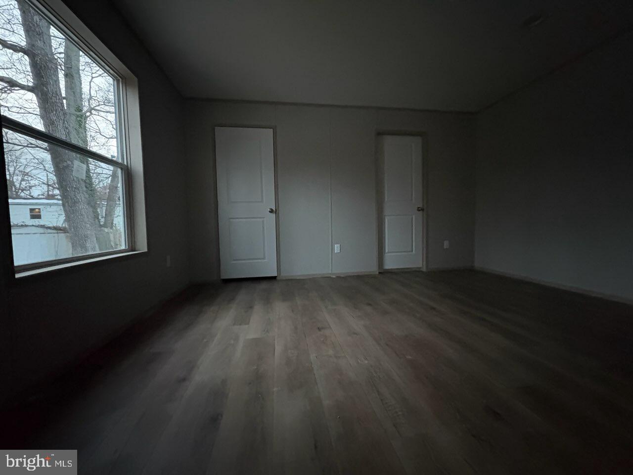 443 Fern Road Millville, NJ 08332 - Photo 15 of 24 a view of an empty room with wooden floor and a window
