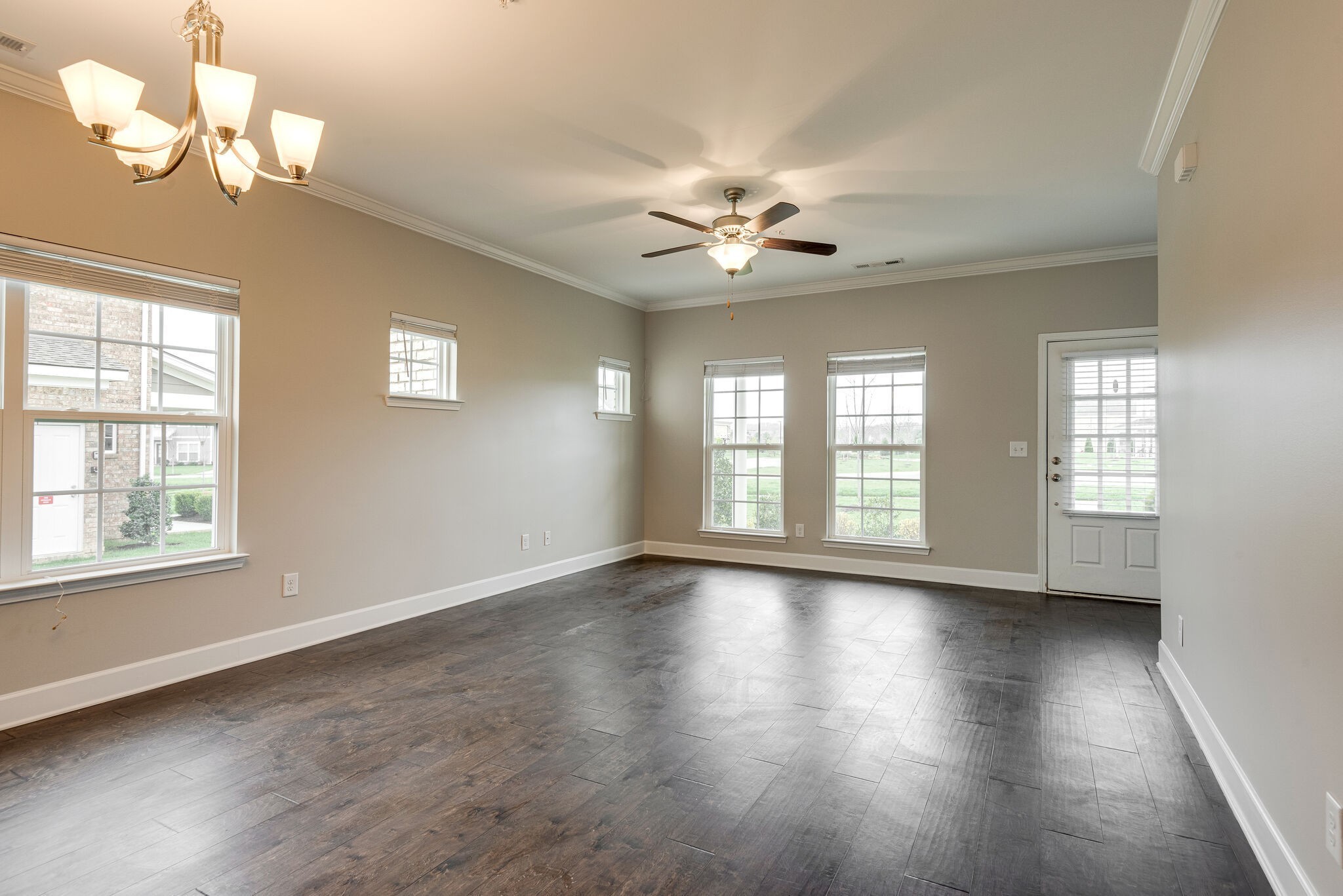 269 Mary Ann Circle Spring Hill, TN 37174 - Photo 6 of 28 a view of an empty room with a window and wooden floor