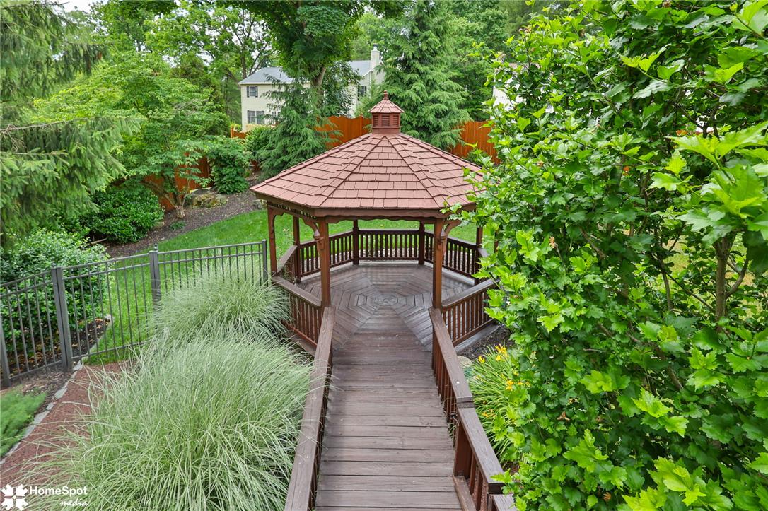 2821 Center Street Bethlehem, PA 18017 - Photo 65 of 68 A charming gazebo with an intricate wooden floor and red shingle roof invites outdoor relaxation.