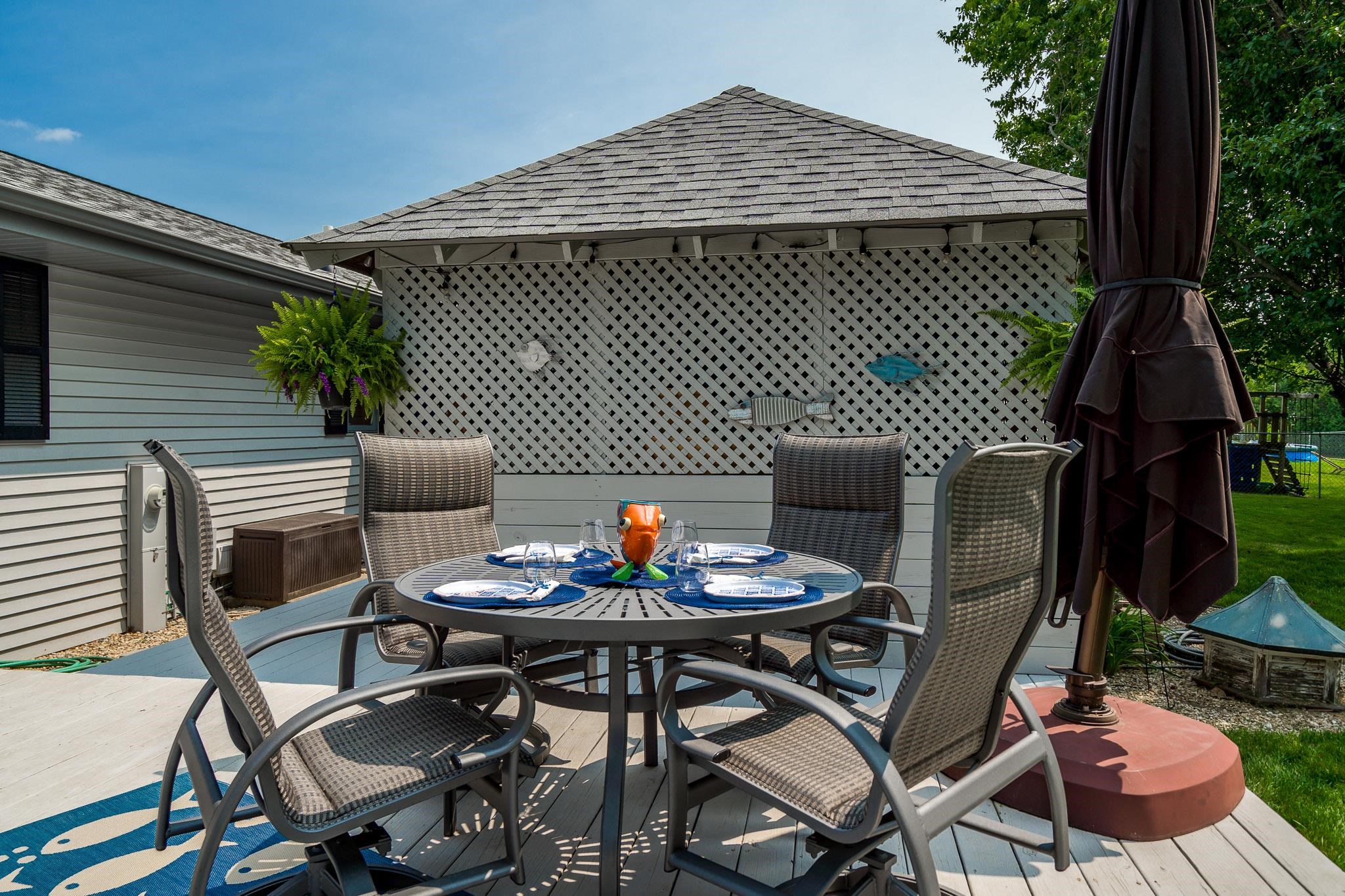 5671 Rural Edge Drive Roscoe, IL 61073 - Photo 36 of 51 a backyard of a house with table and chairs