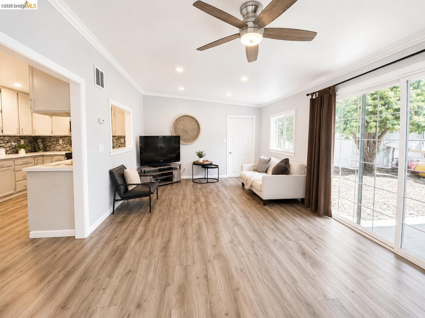 2191 East Cypress Road Oakley, CA 94561 - Photo 11 of 48 Spacious living area featuring wood-finish flooring, recessed lighting, and crown molding