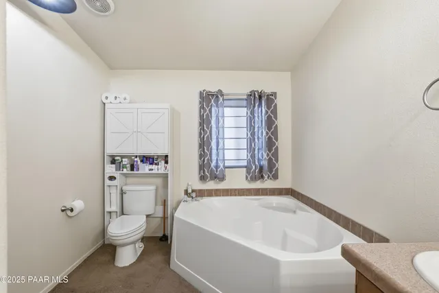 a bathroom with a toilet a sink and bathtub