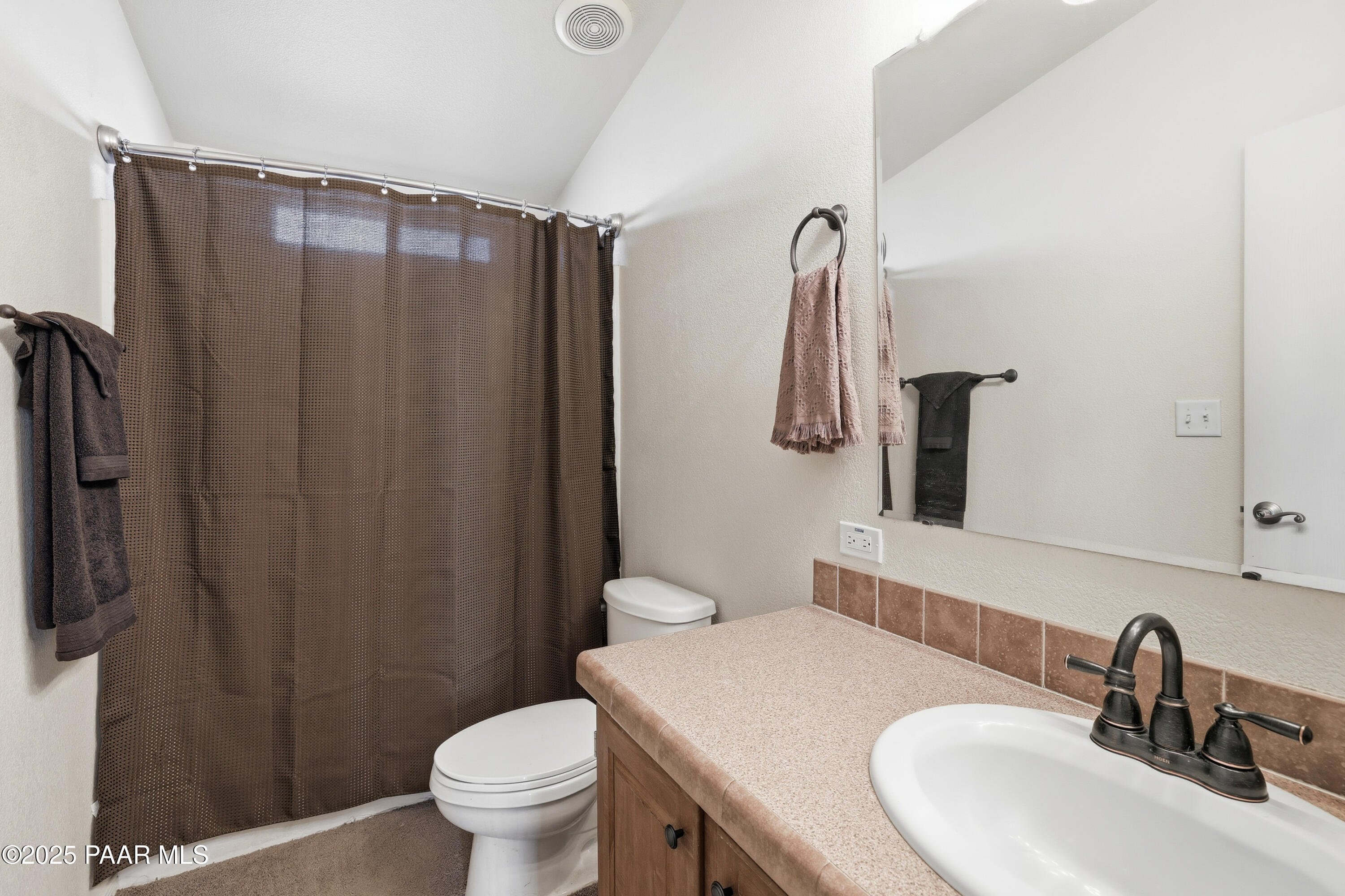 1810 Rhonda Road Chino Valley, AZ 86323 - Photo 20 of 29 a bathroom with a sink a toilet and shower curtain