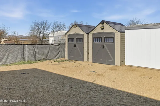a view of a house with a wooden fence