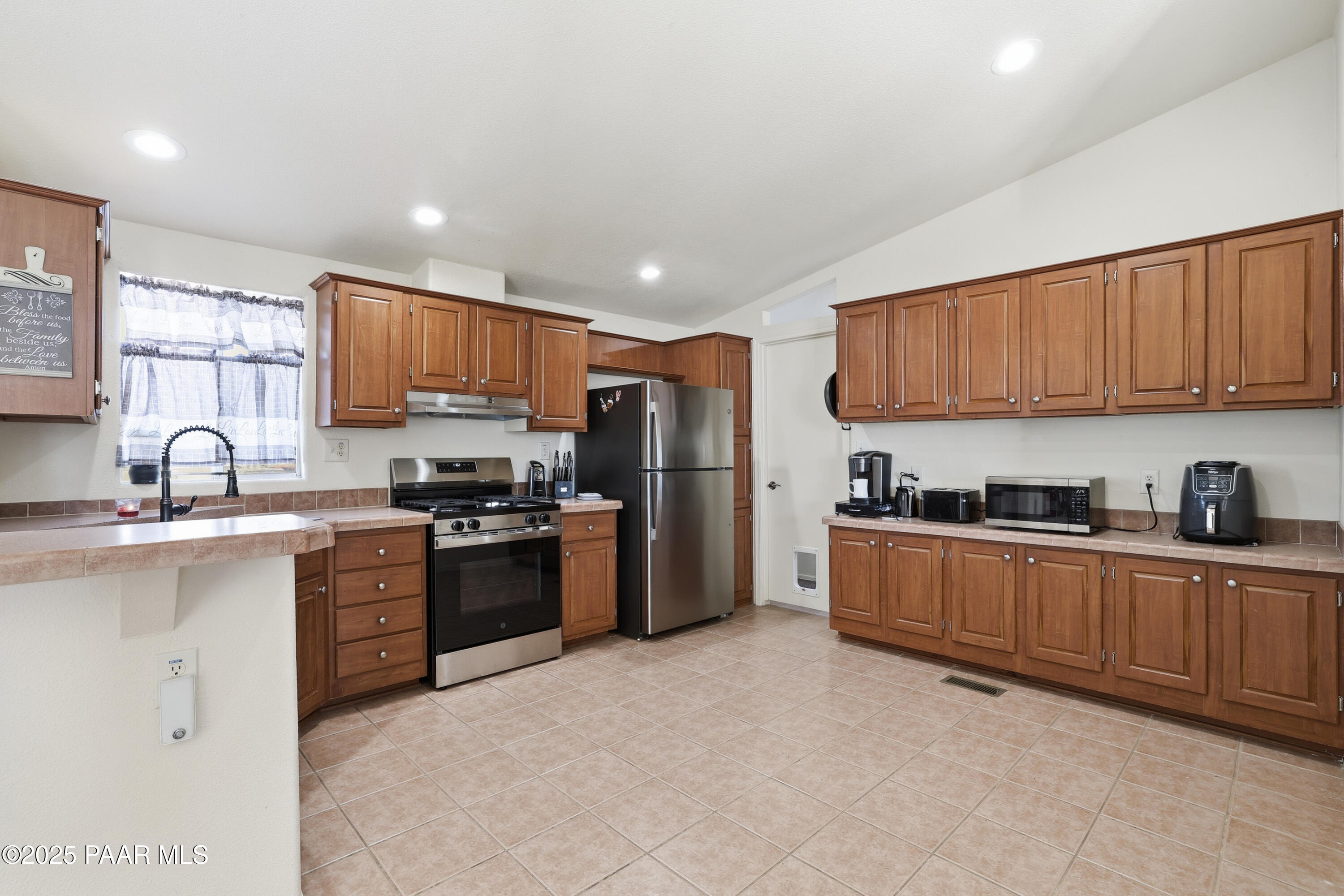 1810 Rhonda Road Chino Valley, AZ 86323 - Photo 8 of 29 a kitchen with stainless steel appliances granite countertop a stove top oven a sink dishwasher a refrigerator and a cabinets with wooden floor