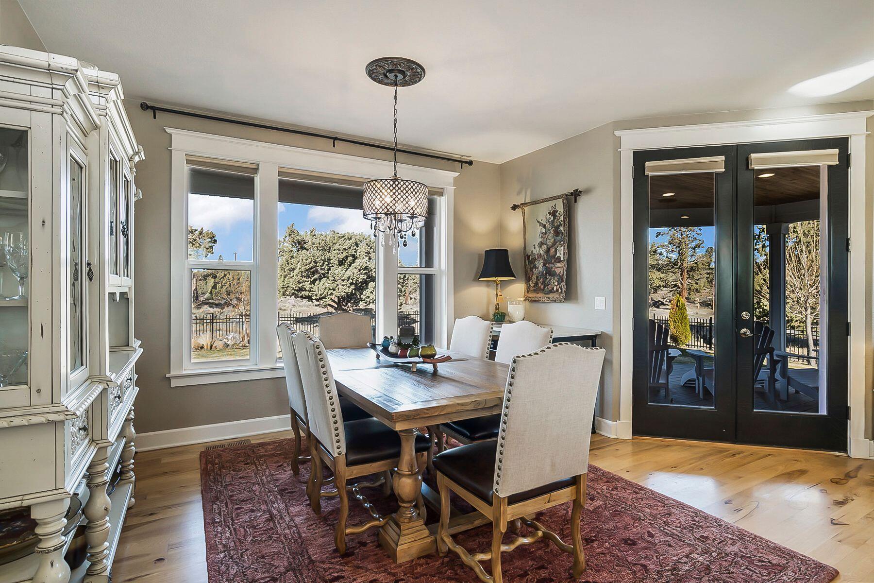 21530 Dale Road Bend, OR 97701 - Photo 15 of 46 a dining room with furniture a chandelier and wooden floor