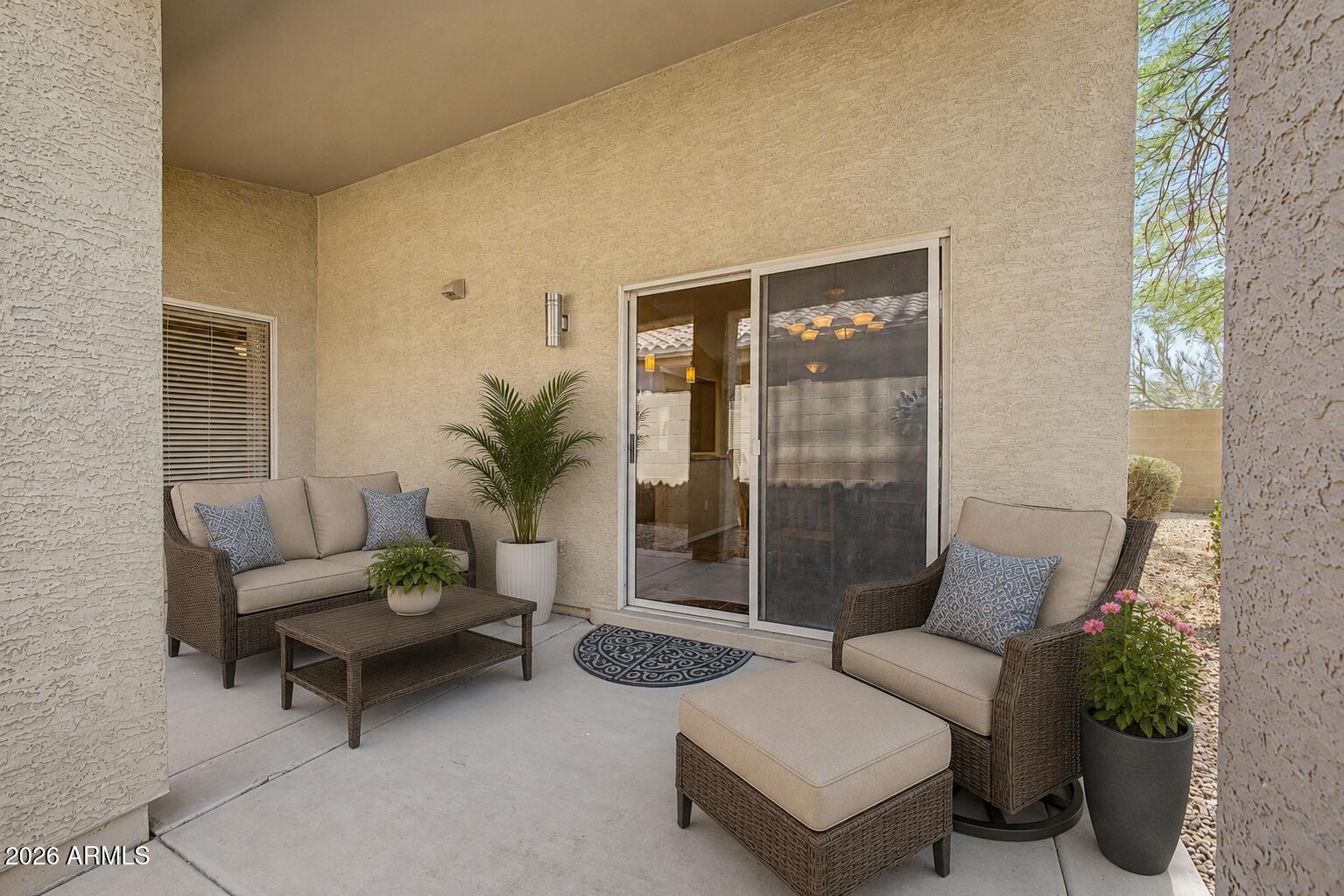 40602 North Apollo Way Anthem, AZ 85086 - Photo 33 of 38 a living room with furniture and a potted plant