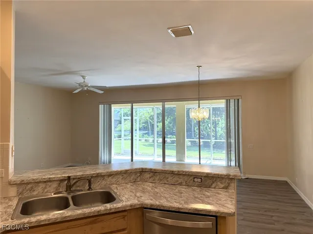 a kitchen with stainless steel appliances a stove microwave and refrigerator
