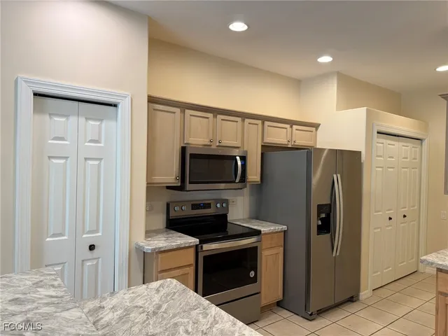 a kitchen with stainless steel appliances a refrigerator and a stove top oven