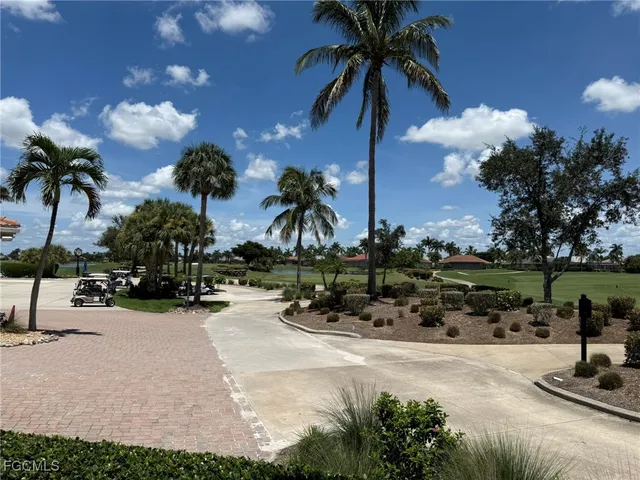 a room with lots of chairs a chandelier and a projector screen