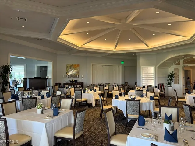 a view of swimming pool with table and chairs potted plants