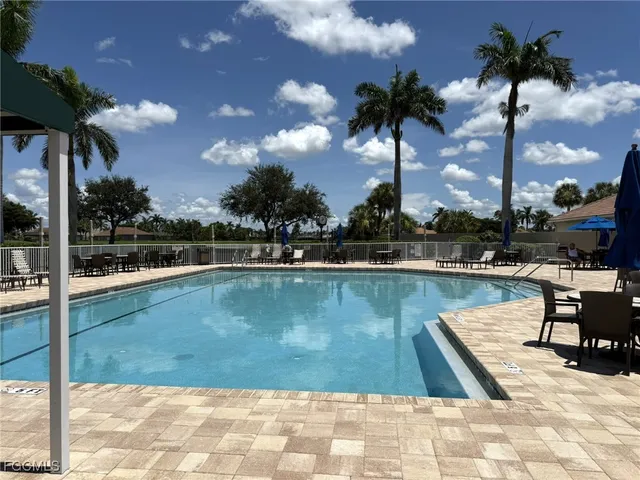 a view of a park with a house in the background