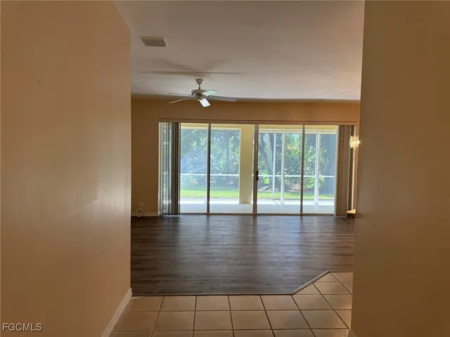a view of an empty room with glass door