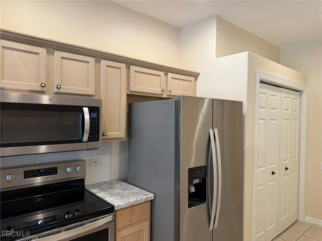 a kitchen with granite countertop cabinets and steel stainless steel appliances