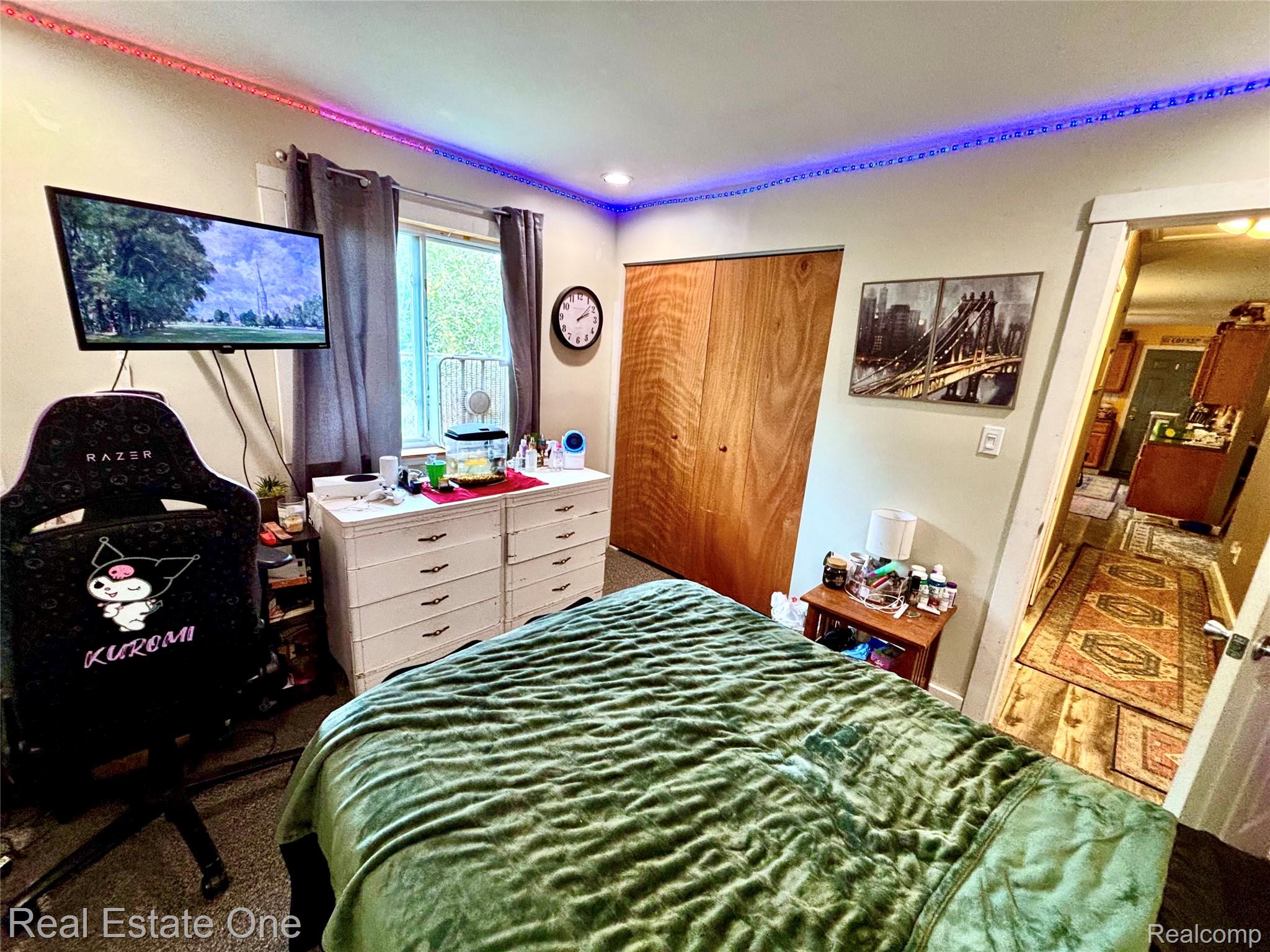 2034 O Brien Road Mayville, MI 48744 - Photo 14 of 24 Recessed ceiling lighting, wall-mounted television, double-door closet, window with drapes, and a white dresser with dark hardware