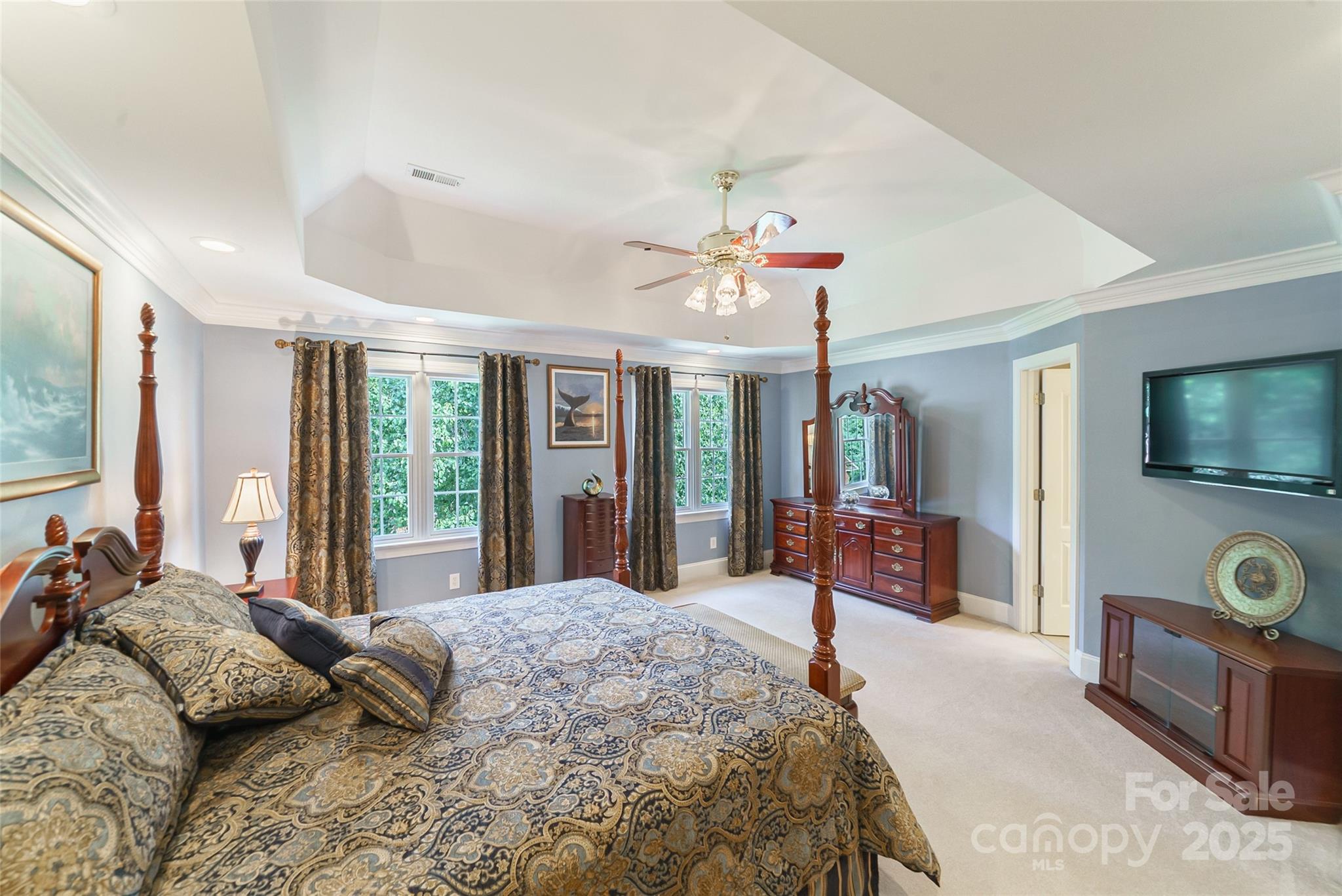 241 Old Springs Road Fort Mill, SC 29715 - Photo 25 of 48 a spacious bedroom with a large bed and a flat screen tv