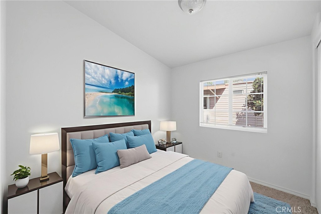 12147 Lakeland Road, Unit 9 Santa Fe Springs, CA 90670 - Photo 13 of 23 a bedroom with a bed and a painting on the wall