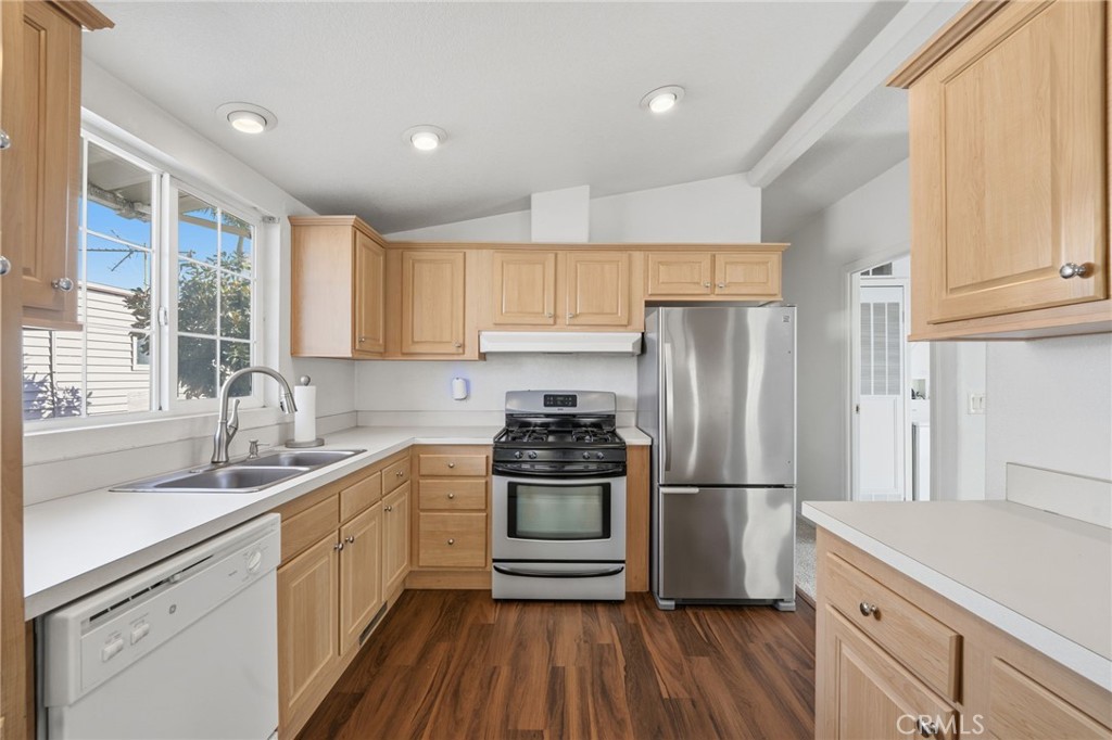 12147 Lakeland Road, Unit 9 Santa Fe Springs, CA 90670 - Photo 4 of 23 a kitchen with kitchen island granite countertop a sink stainless steel appliances and cabinets