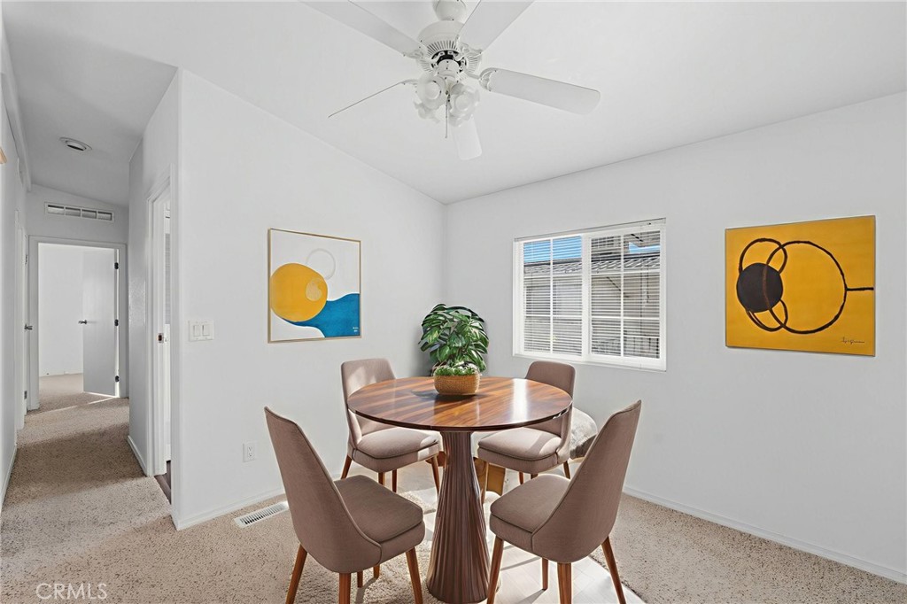 12147 Lakeland Road, Unit 9 Santa Fe Springs, CA 90670 - Photo 9 of 23 a view of a dining room with furniture and chandelier