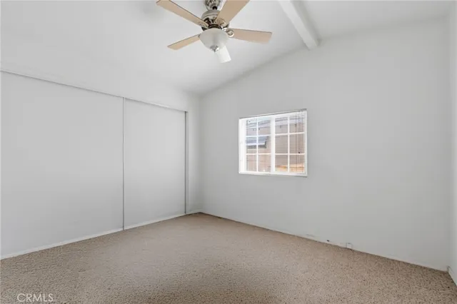 a bedroom with a bed and a potted plant