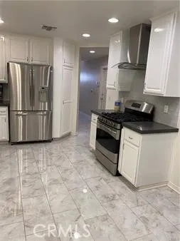 a white refrigerator freezer sitting in a kitchen