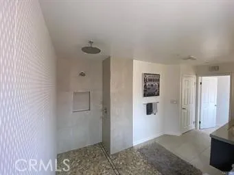 a spacious bathroom with a granite countertop sink a mirror and a bathtub