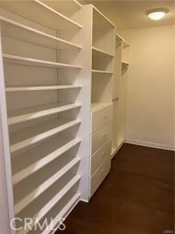 a view of a patio with table and chairs potted plants and palm tree