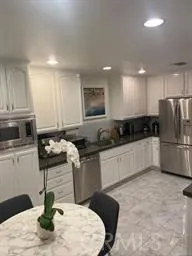 a kitchen with a stove a refrigerator and a sink