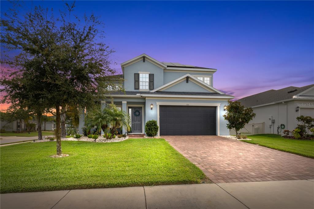 720 Cajeput Loop Tarpon Springs, FL 34689 - Photo 1 of 1 a front view of a house with a yard and garage