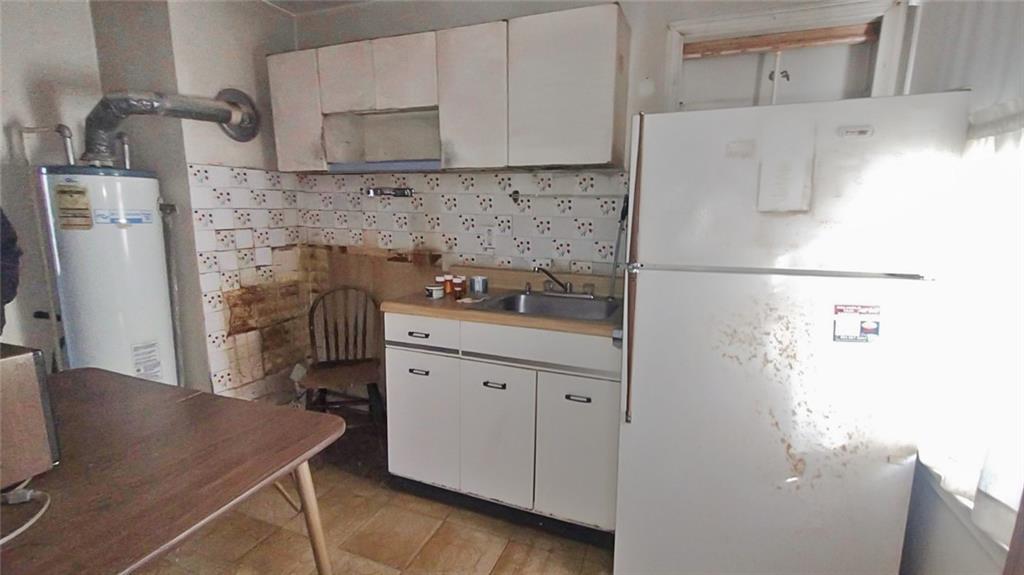 1900 Francis Avenue Northwest Atlanta, GA 30318 - Photo 3 of 9 a kitchen with a refrigerator sink and cabinets
