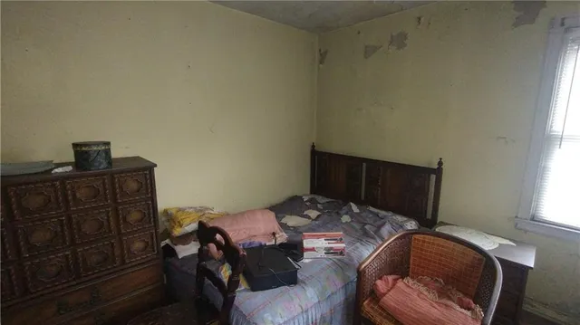 a bedroom with a bed and dresser