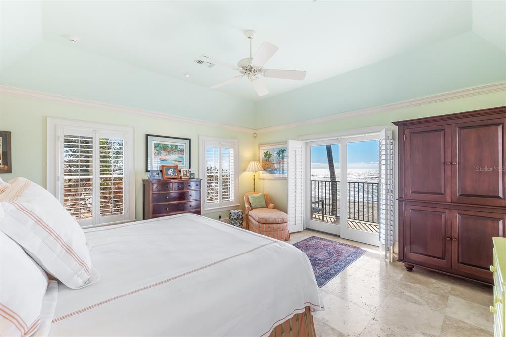 2571 Shore Lane Boca Grande, FL 33921 - Photo 11 of 38 a bedroom with a large bed and wooden floor