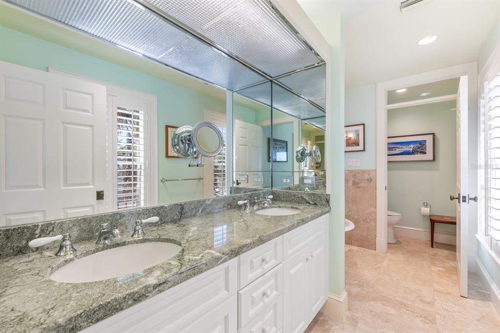 2571 Shore Lane Boca Grande, FL 33921 - Photo 12 of 38 a bathroom with a granite countertop sink and a mirror