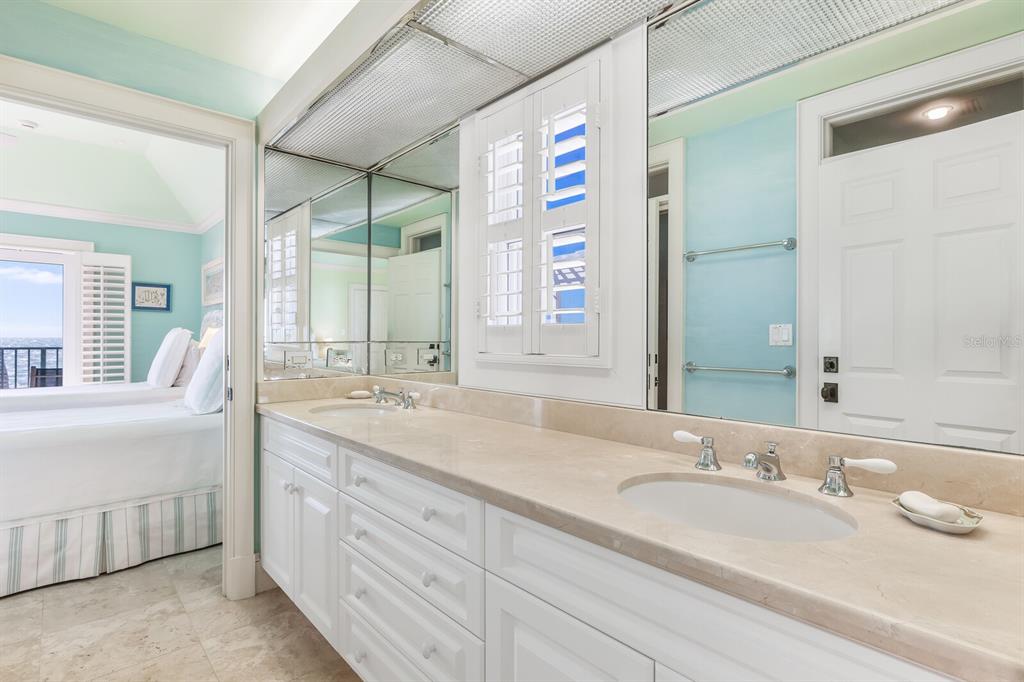 2571 Shore Lane Boca Grande, FL 33921 - Photo 14 of 38 a bathroom with a granite countertop sink and a mirror