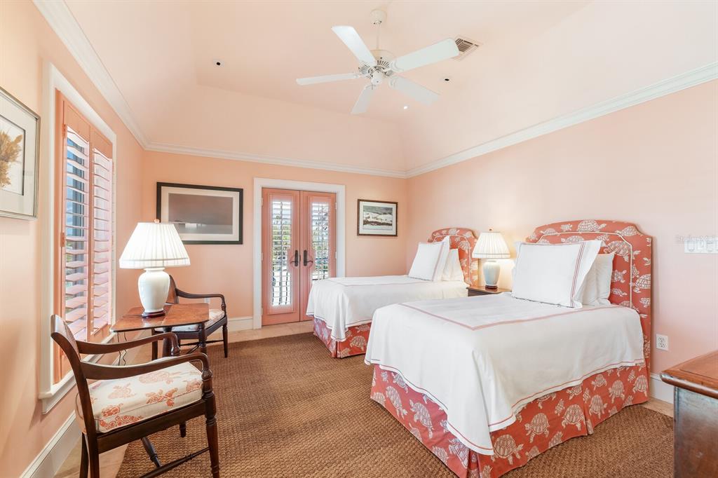 2571 Shore Lane Boca Grande, FL 33921 - Photo 16 of 38 a bedroom with a bed and a chandelier
