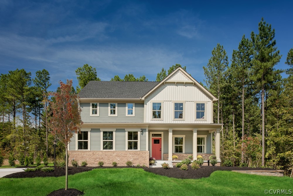 a front view of a house with a yard and green space