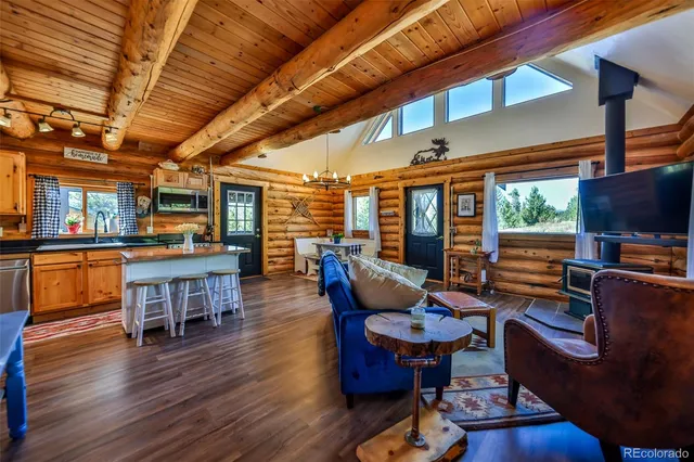 a living room with furniture a flat screen tv and windows