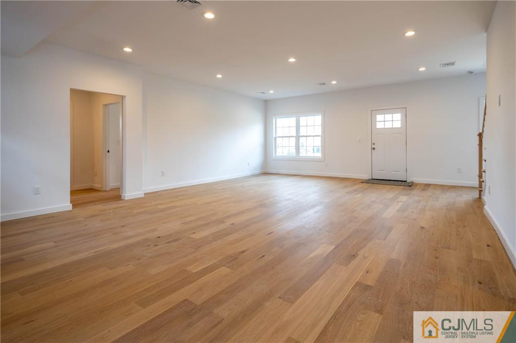 20 Kenmore Road Edison, NJ 08817 - Photo 15 of 32 an empty room with wooden floor and windows